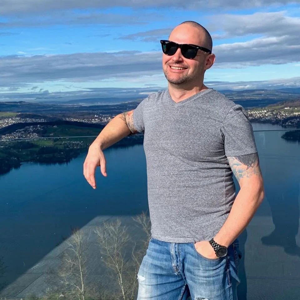 Brian Orr overlooking a lake and mountains while traveling abroad.